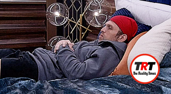 Man in a red fez relaxing on a couch with decorative glass orbs behind him. Man in a red fez relaxing on a couch with decorative glass orbs behind him.