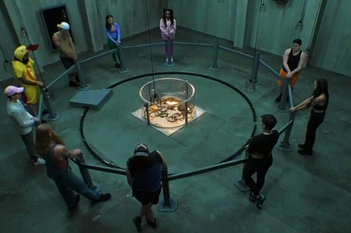 People standing in a circle around a fire pit in a dimly lit room. People standing in a circle around a fire pit in a dimly lit room.