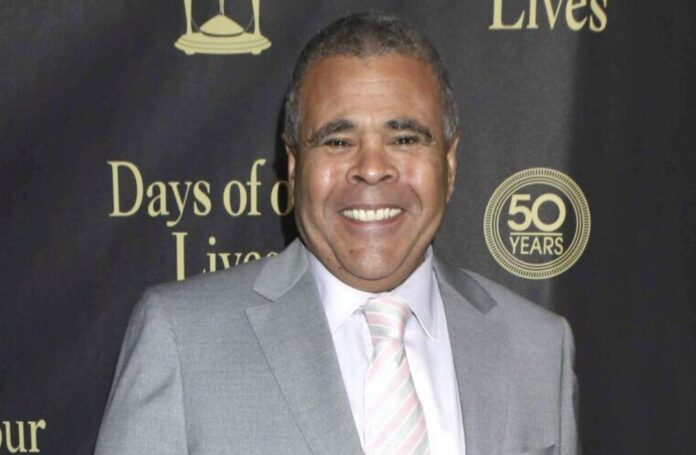 Smiling man in a gray suit at a formal event. Smiling man in a gray suit at a formal event.
