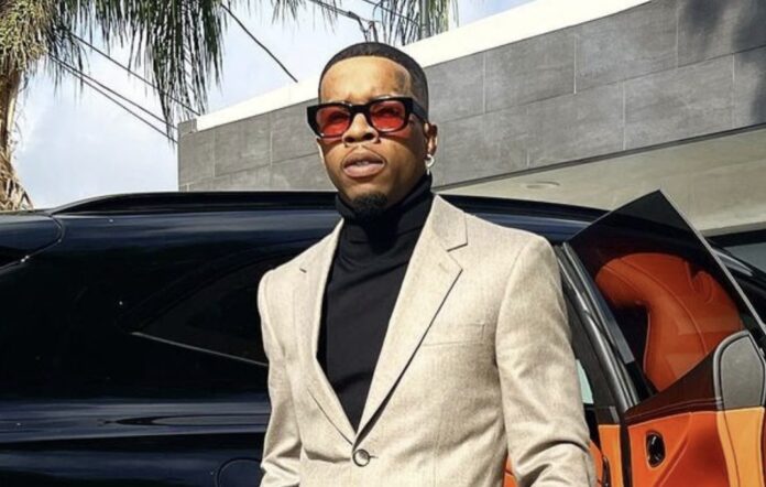 Man in beige suit and sunglasses standing by a car. Man in beige suit and sunglasses standing by a car.