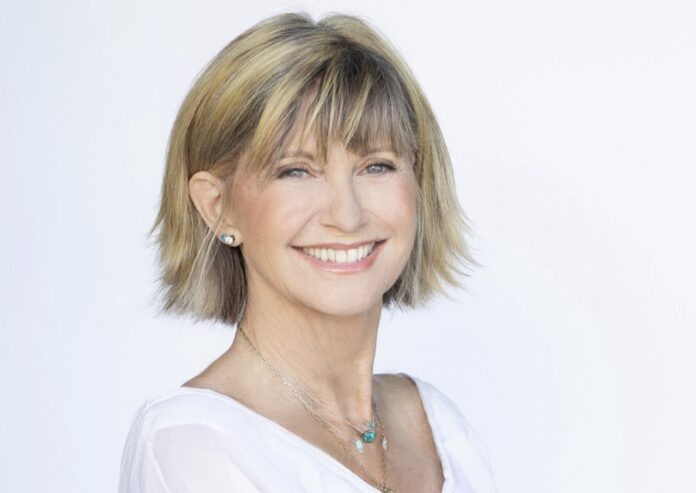 Smiling woman with short blonde hair against a white background. Smiling woman with short blonde hair against a white background.