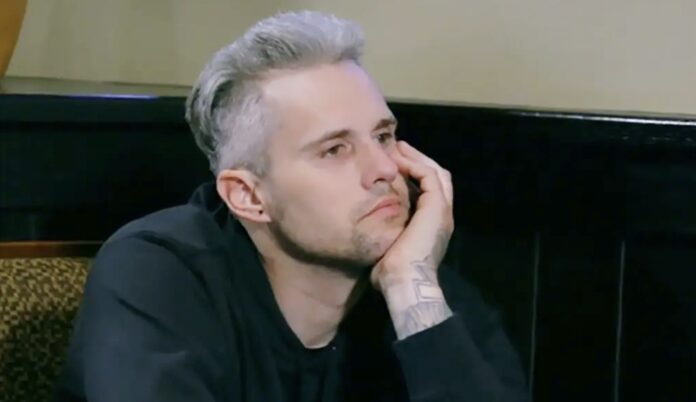 A man with light hair resting his face on his hand, looking thoughtful. A man with light hair resting his face on his hand, looking thoughtful.