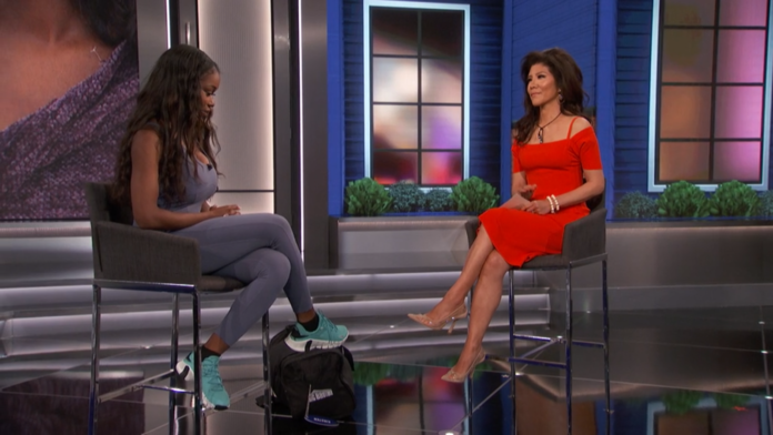 Two women engaged in a serious conversation on a talk show set. Two women engaged in a serious conversation on a talk show set.
