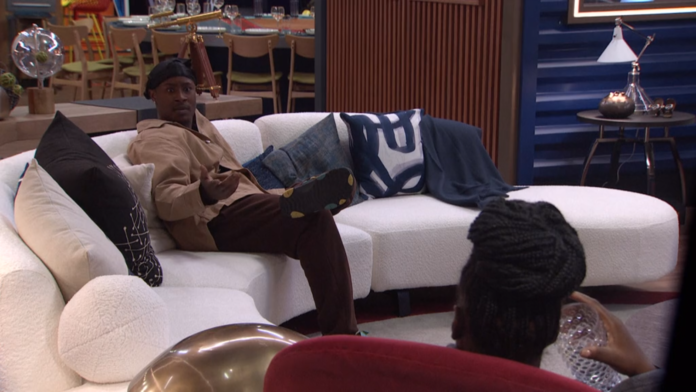 Man relaxing on a white couch in a cozy living room. Man relaxing on a white couch in a cozy living room.