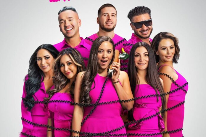 Group of eight people in matching pink outfits posing together. Group of eight people in matching pink outfits posing together.