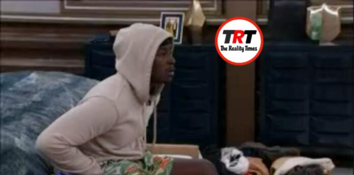 Person in a light hoodie sitting indoors, looking focused. Person in a light hoodie sitting indoors, looking focused.