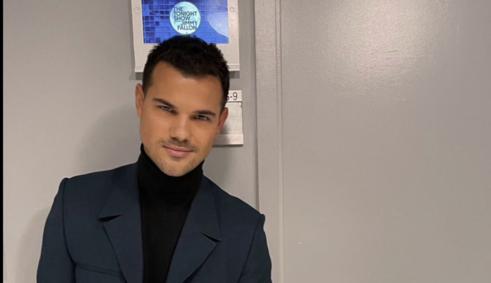 Man in dark blazer and turtleneck smiling indoors. Man in dark blazer and turtleneck smiling indoors.