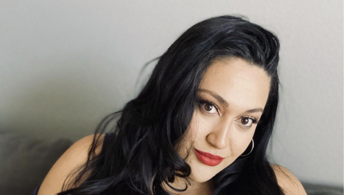 Woman with long black hair and red lipstick smiling gently. Woman with long black hair and red lipstick smiling gently.