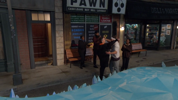 Two men hugging outside a pawn shop at night. Two men hugging outside a pawn shop at night.