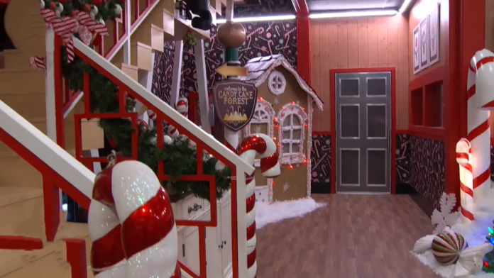 Festive holiday decorations with a gingerbread house and Christmas tree indoors. Festive holiday decorations with a gingerbread house and Christmas tree indoors.
