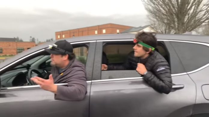Two men leaning out of a car window, engaged in conversation. Two men leaning out of a car window, engaged in conversation.