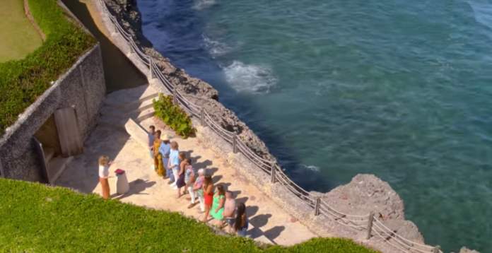 Group of people exercising outdoors near rocky coastline and ocean. Group of people exercising outdoors near rocky coastline and ocean.