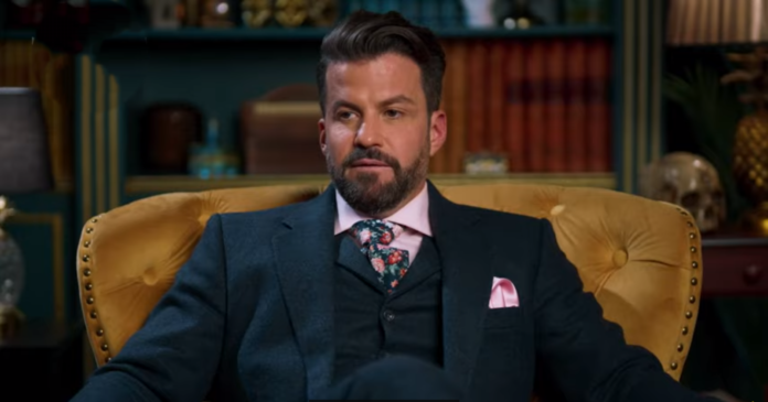 Man in a formal suit with a patterned tie and pocket square. Man in a formal suit with a patterned tie and pocket square.