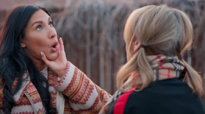 Two women in an emotional moment, one touching the other's face gently. Two women in an emotional moment, one touching the other's face gently.