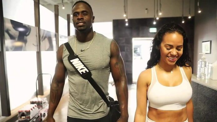 Two fit individuals in workout attire smiling indoors. Two fit individuals in workout attire smiling indoors.