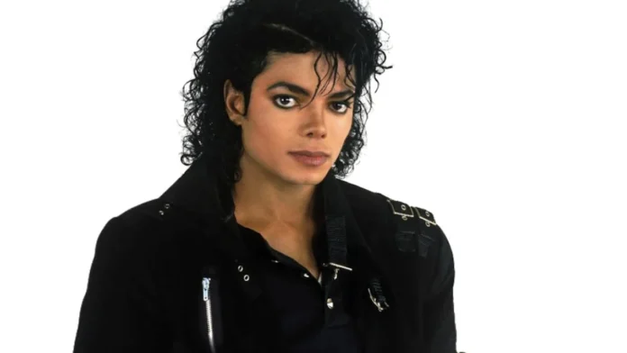 Michael Jackson in a black jacket with curly hair. Michael Jackson in a black jacket with curly hair.