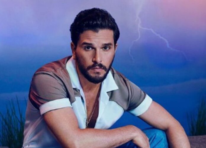 Man with a beard posing against a stormy sky background. Man with a beard posing against a stormy sky background.