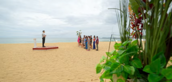 People gathered on a sandy beach under a cloudy sky. People gathered on a sandy beach under a cloudy sky.