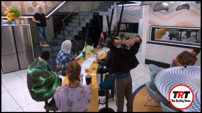 People gathered around a table in a casual setting, some with hands on heads. People gathered around a table in a casual setting, some with hands on heads.