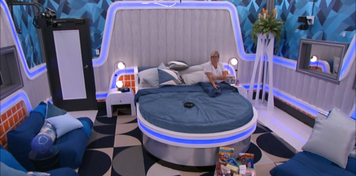 A futuristic bedroom with a round bed and neon blue lighting. A futuristic bedroom with a round bed and neon blue lighting.