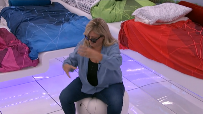 Person sitting on an exercise ball indoors, adjusting glasses. Person sitting on an exercise ball indoors, adjusting glasses.