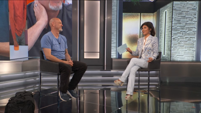 Two people engaged in a television interview on a modern set. Two people engaged in a television interview on a modern set.