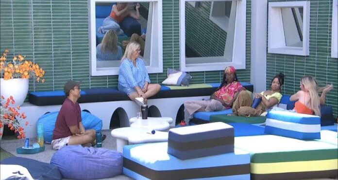 People relaxing and chatting in a cozy indoor lounge area. People relaxing and chatting in a cozy indoor lounge area.