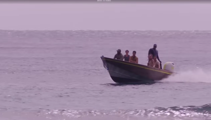 People on a small boat in calm sea waters. People on a small boat in calm sea waters.