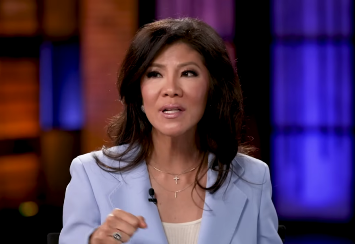 Woman in a light blue blazer speaking on a talk show. Woman in a light blue blazer speaking on a talk show.