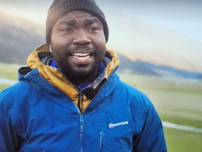 Man smiling outdoors in blue jacket and beanie. Man smiling outdoors in blue jacket and beanie.