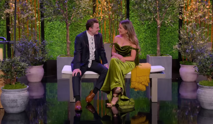 A man and woman sit closely on a bench, engaged in conversation. A man and woman sit closely on a bench, engaged in conversation.