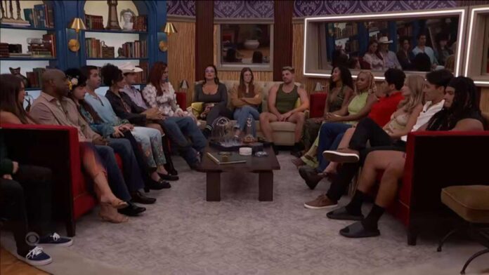 A group of people seated in a living room engaged in conversation. A group of people seated in a living room engaged in conversation.