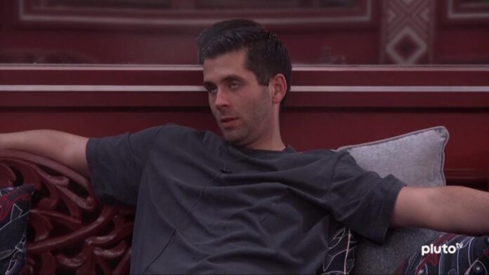 Man sitting relaxed on a couch in a dark shirt. Man sitting relaxed on a couch in a dark shirt.