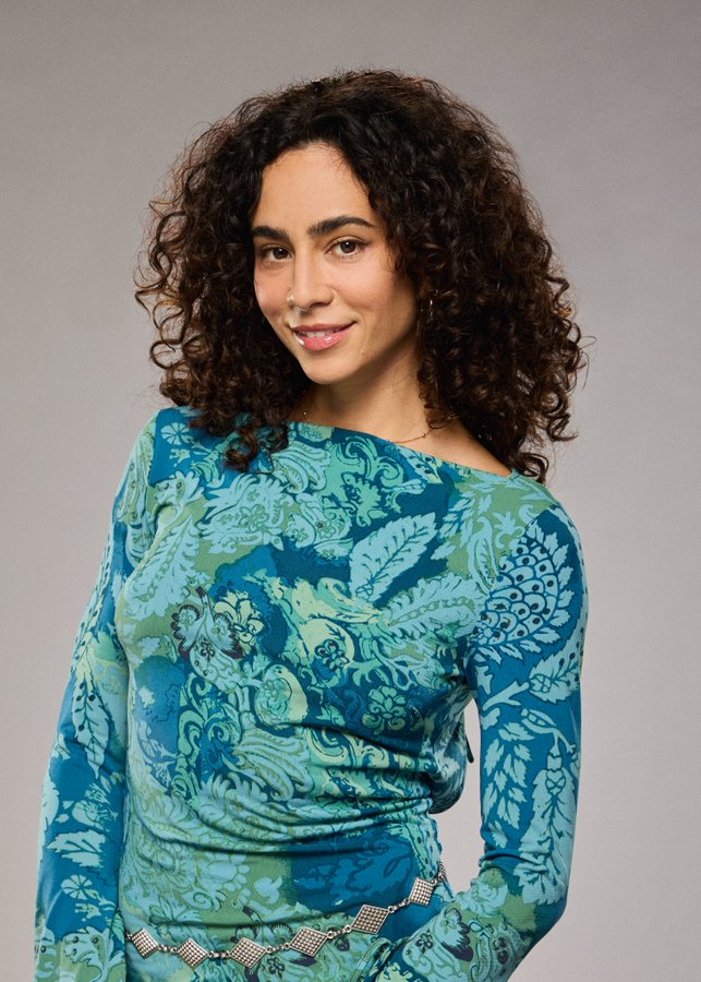 A beach at sunset with vibrant colors and calm waves.