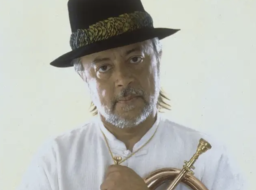 A beach at sunset with vibrant colors and calm waves.