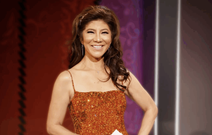 Smiling woman in an elegant orange dress on stage. Smiling woman in an elegant orange dress on stage.