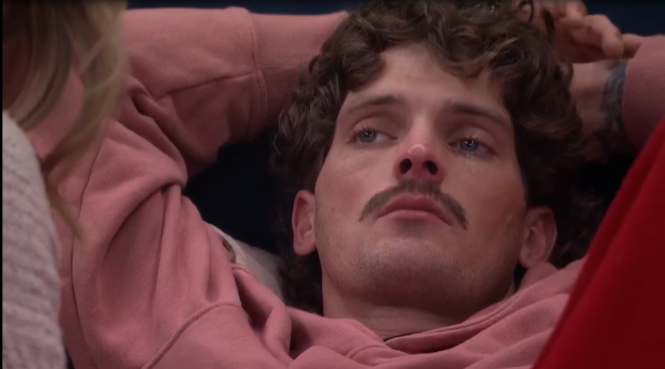 A beach at sunset with vibrant colors and calm waves.