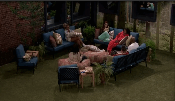 People relaxing and chatting in an outdoor seating area at night. People relaxing and chatting in an outdoor seating area at night.