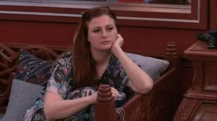 Woman sitting pensively on a wooden bench. Woman sitting pensively on a wooden bench.