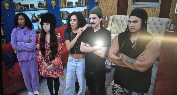 Four people posing indoors, dressed in casual and eclectic styles. Four people posing indoors, dressed in casual and eclectic styles.