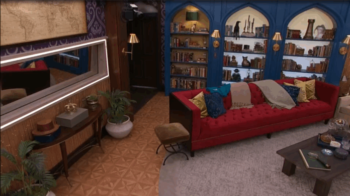 Cozy living room with red sofa, bookshelf, and warm lighting. Cozy living room with red sofa, bookshelf, and warm lighting.