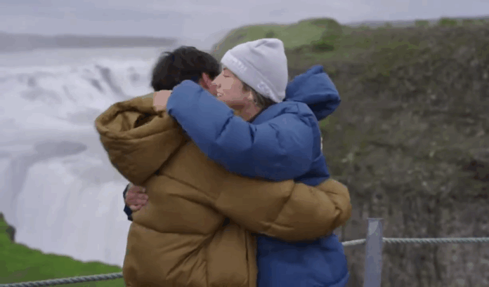Two people warmly hugging outdoors in winter clothing. Two people warmly hugging outdoors in winter clothing.