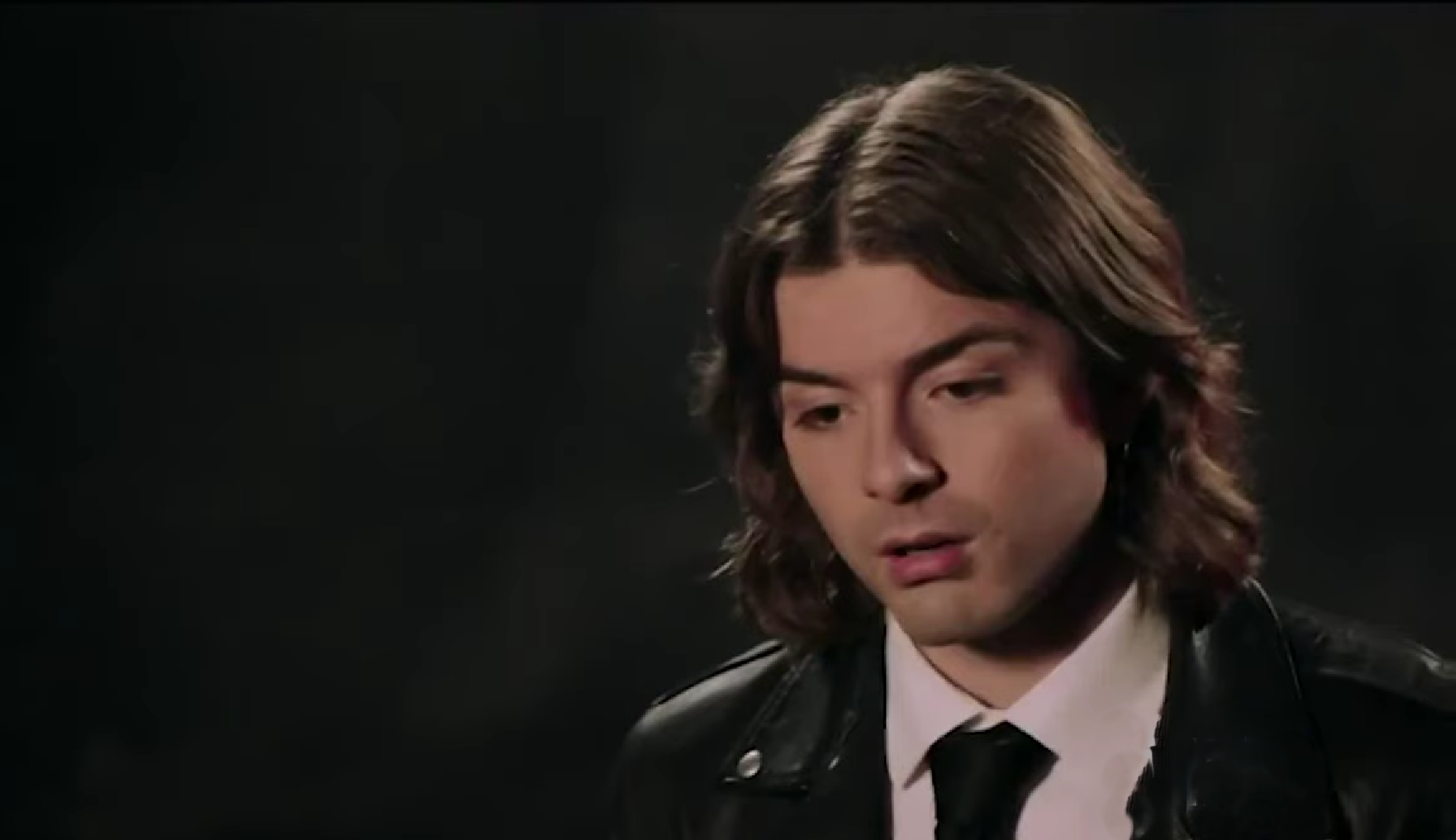 A beach at sunset with vibrant colors and calm waves.