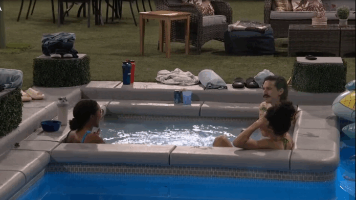 Two men relaxing and talking in a hot tub indoors. Two men relaxing and talking in a hot tub indoors.