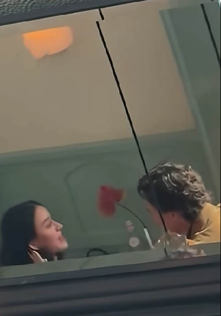 Two people sharing a light moment with a heart balloon between them.