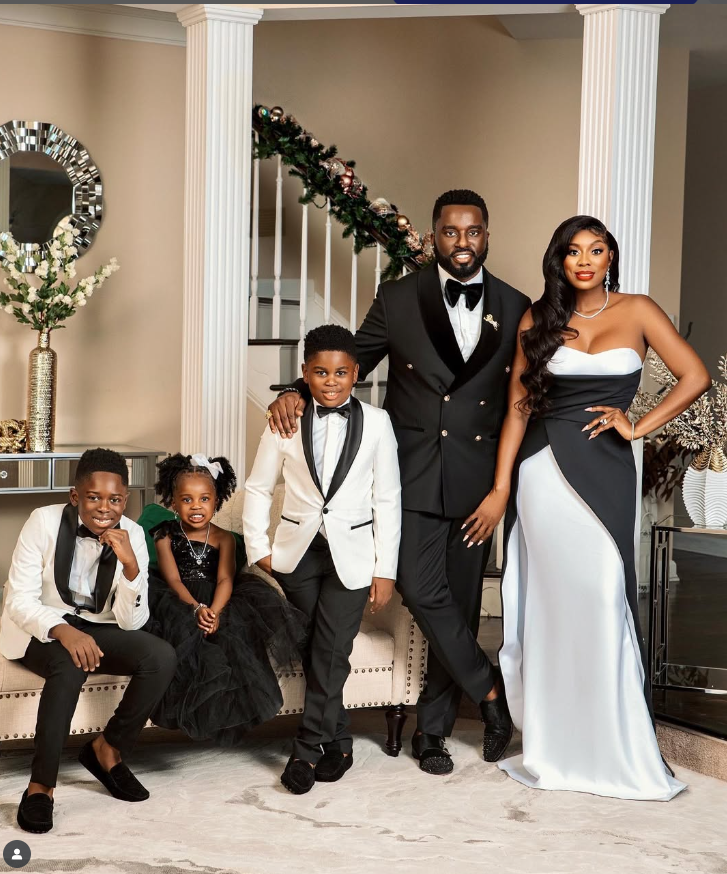 Elegant family dressed in formal attire posing indoors.